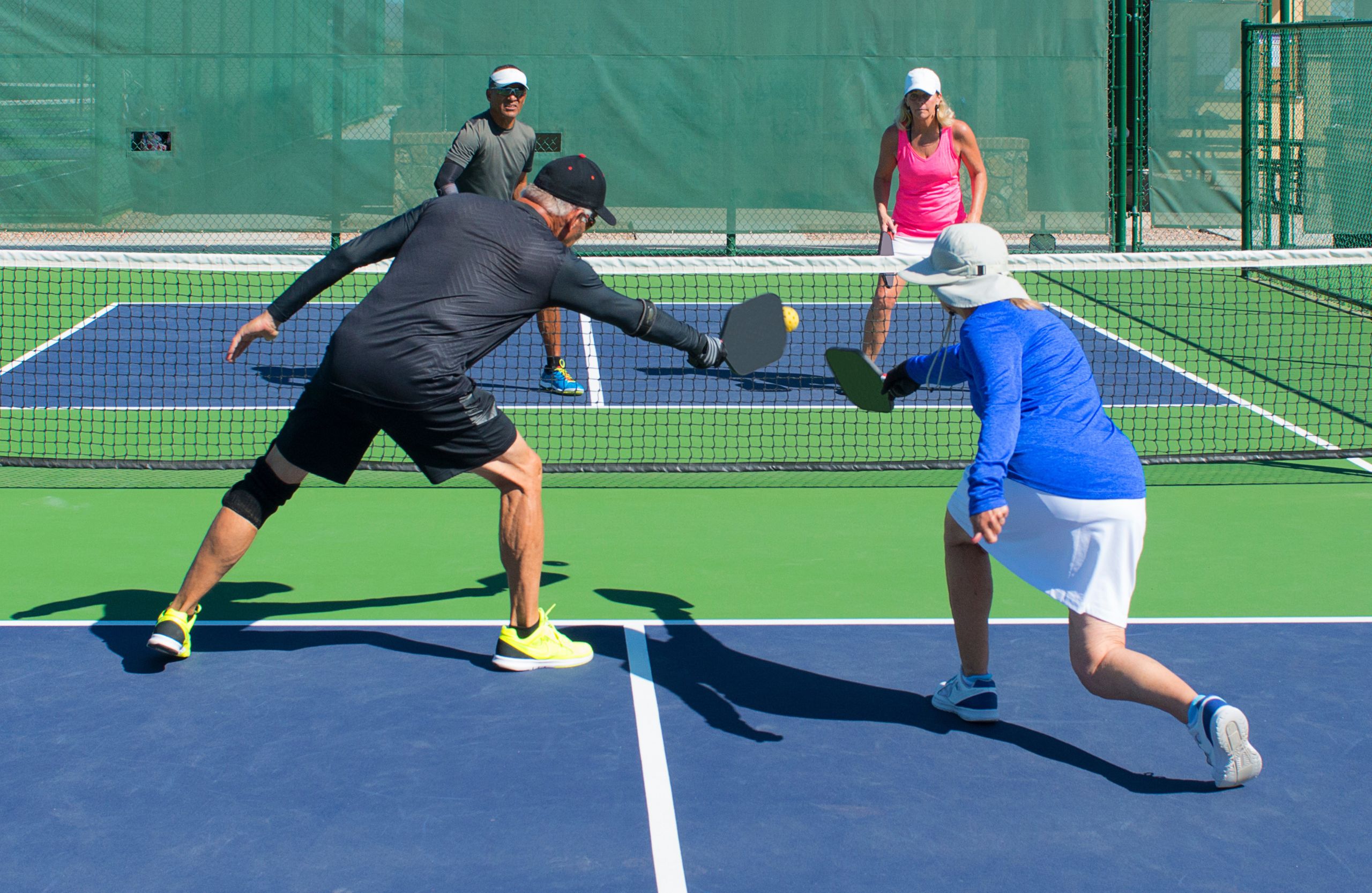 Seniors playing squash on a court at a senior living community in Oconee, GA.